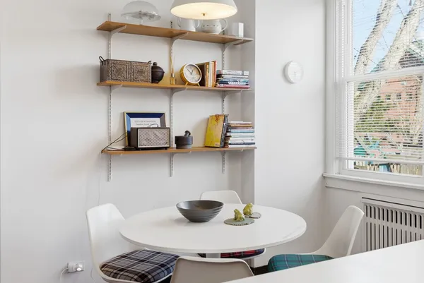 a dining room with two chairs and a table