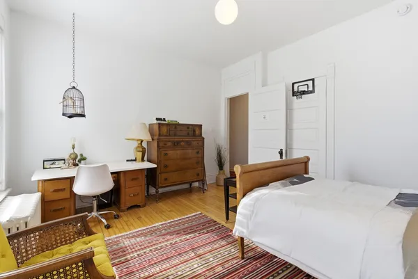 a bedroom with a bed and a table