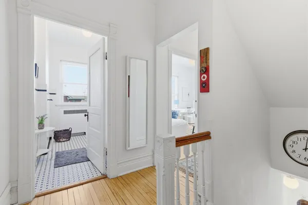a view of an entryway with wooden floor