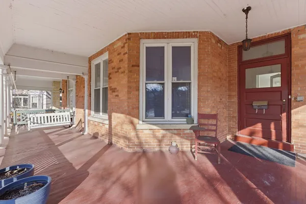a view of a balcony with a floor to ceiling window and wooden floor