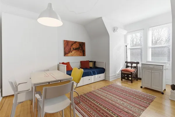 a bedroom with furniture and a wooden floor