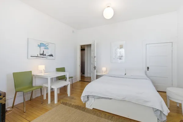 a bedroom with a bed and a chair in it