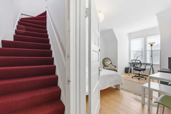 a view of entryway and hall with wooden floor