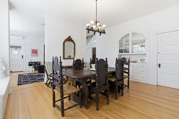 a view of a dining room with furniture and wooden floor