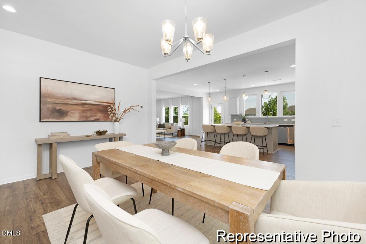 47 Flicker Lane, Unit 188P Angier, NC 27501 - Photo 10 of 38 a view of a dining room with furniture and a chandelier