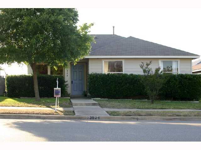 13824 Spring Heath Road Pflugerville, TX 78660 - Photo 1 of 1 a front view of a house with a yard and garage