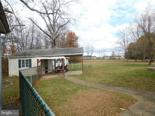 a front view of house with yard and trees