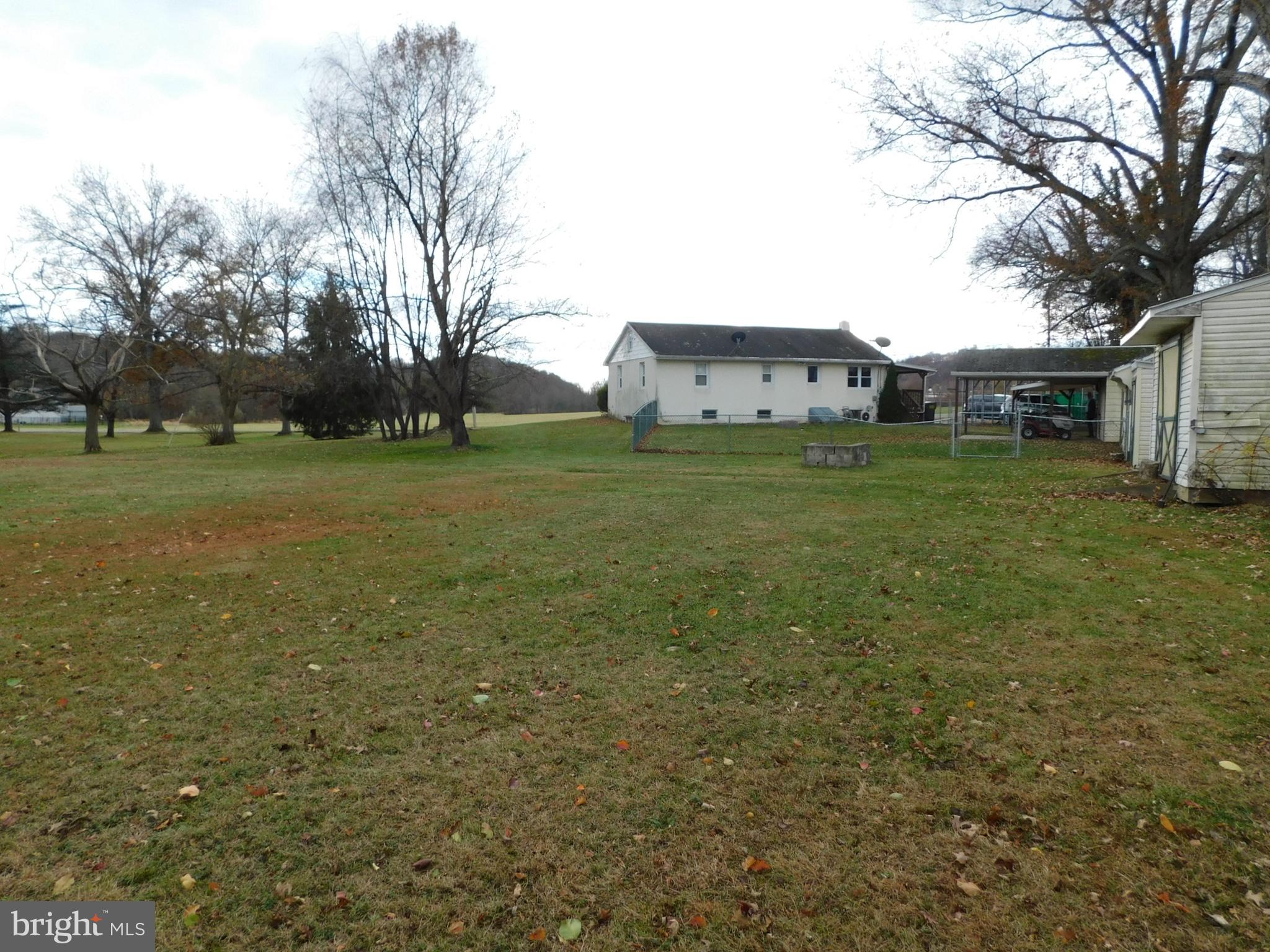 115 Limekiln Road Bechtelsville, PA 19505 - Photo 14 of 17 a view of a large house with a big yard and large trees