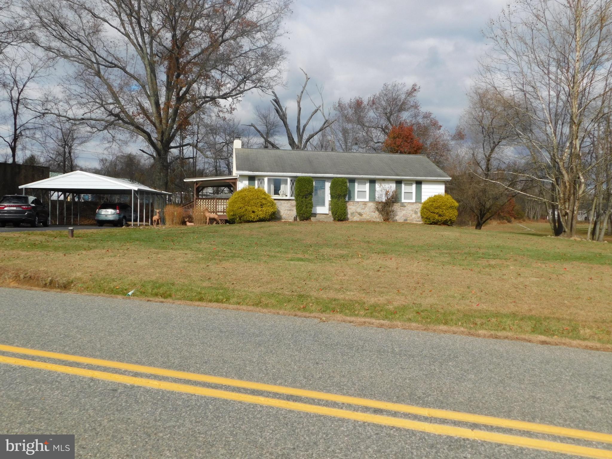 115 Limekiln Road Bechtelsville, PA 19505 - Photo 2 of 17 a front view of a house with a garden and trees