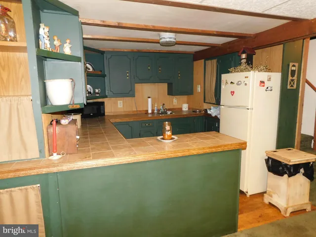 a kitchen with a refrigerator and a stove