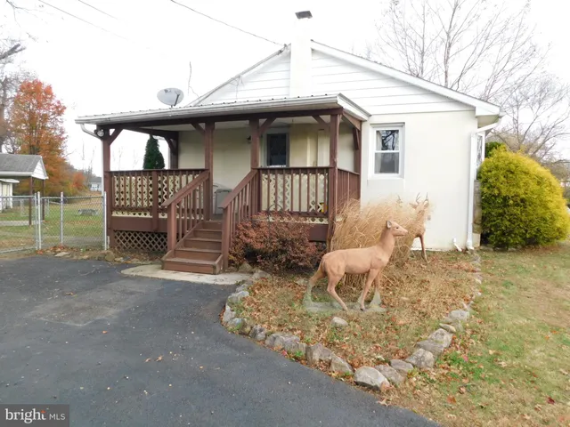 a view of a house with a bed and wooden fence