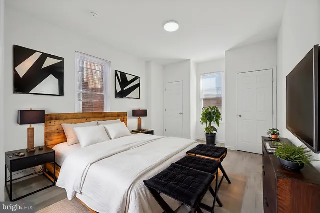 a bedroom with a bed and a flat screen tv