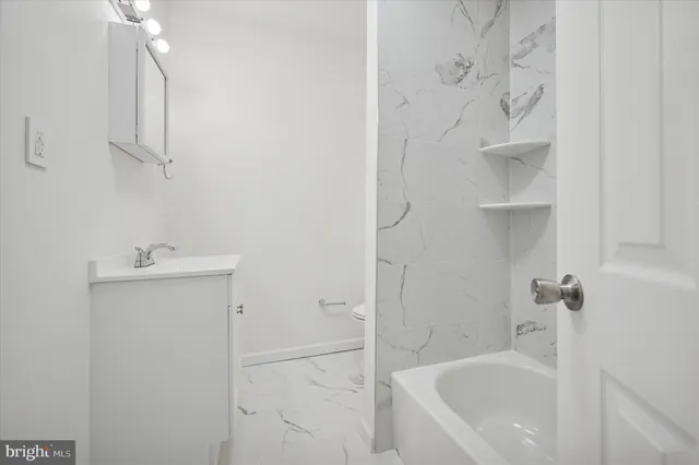 a bathroom with a bathtub and shower