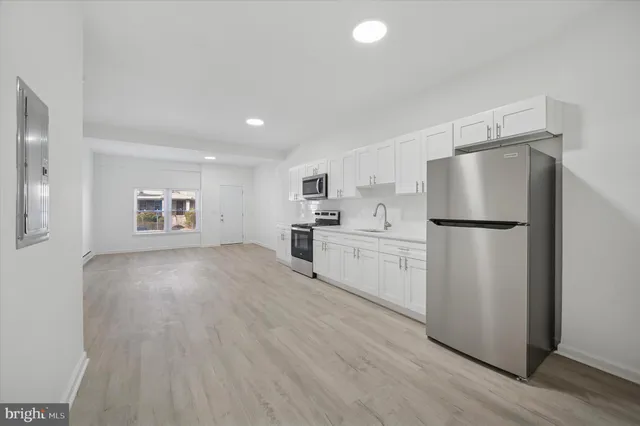 a kitchen with a refrigerator a stove top oven and a refrigerator