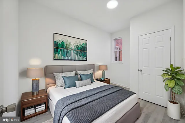 a bedroom with a bed and a potted plant