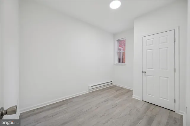 a view of room with wooden floor