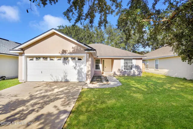 a view of a house with a yard and sitting area