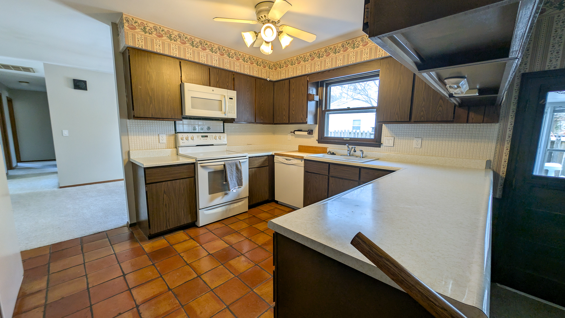 502 South Main Street St. Joseph, IL 61873 - Photo 7 of 25 a kitchen that has a sink and a stove in it