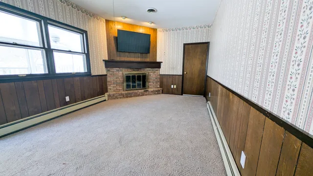 a view of a livingroom with an empty space and a fireplace