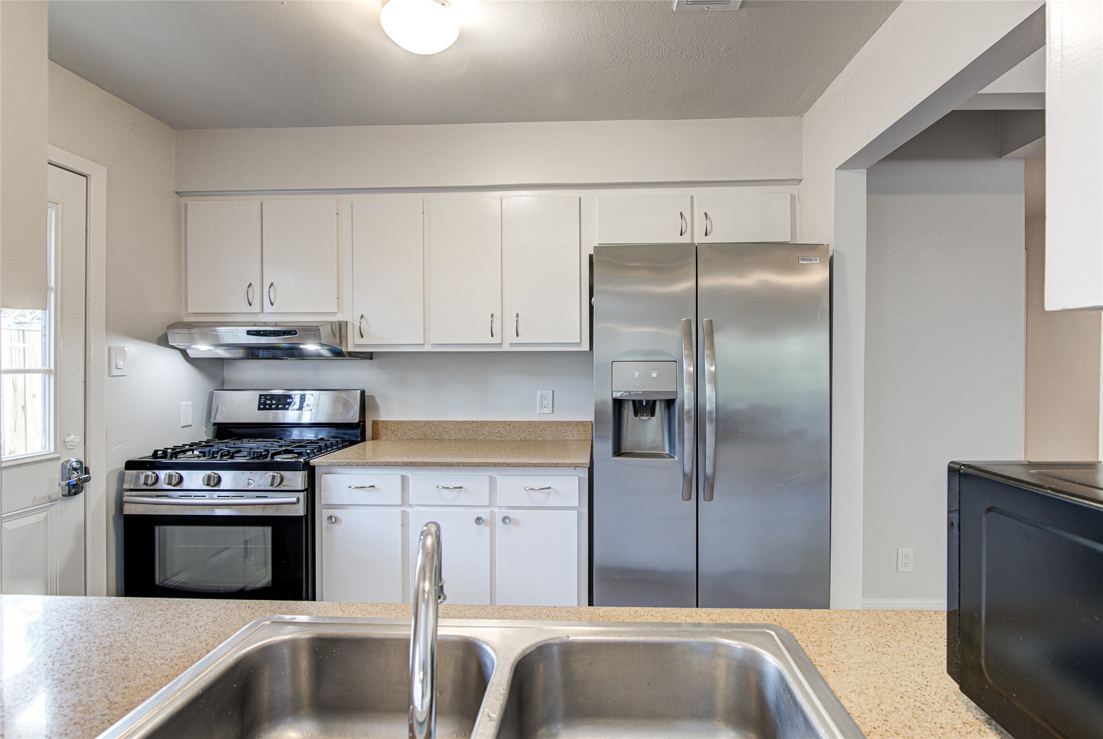 311 West Mary Street Austin, TX 78704 - Photo 26 of 35 The kitchen offers ample cabinetry, modern stainless steel appliances, and practical counter space for daily living.