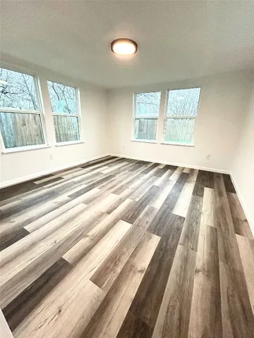 a white toilet sitting next to a white cabinet