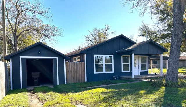a view of a house with a yard in front of house