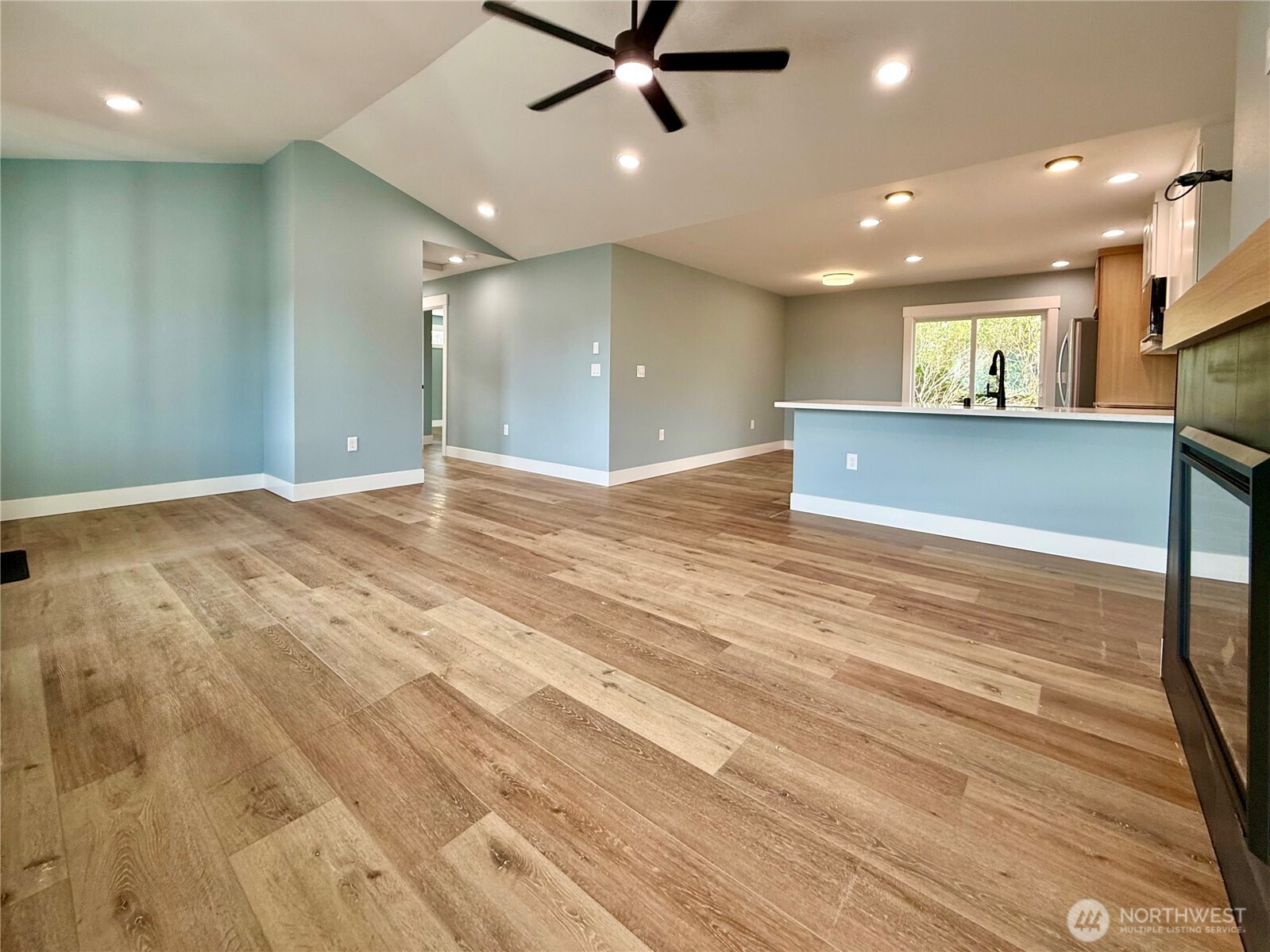 716 Reporter Court Southwest Ocean Shores, WA 98569 - Photo 12 of 36 a view of a big room with wooden floor and windows