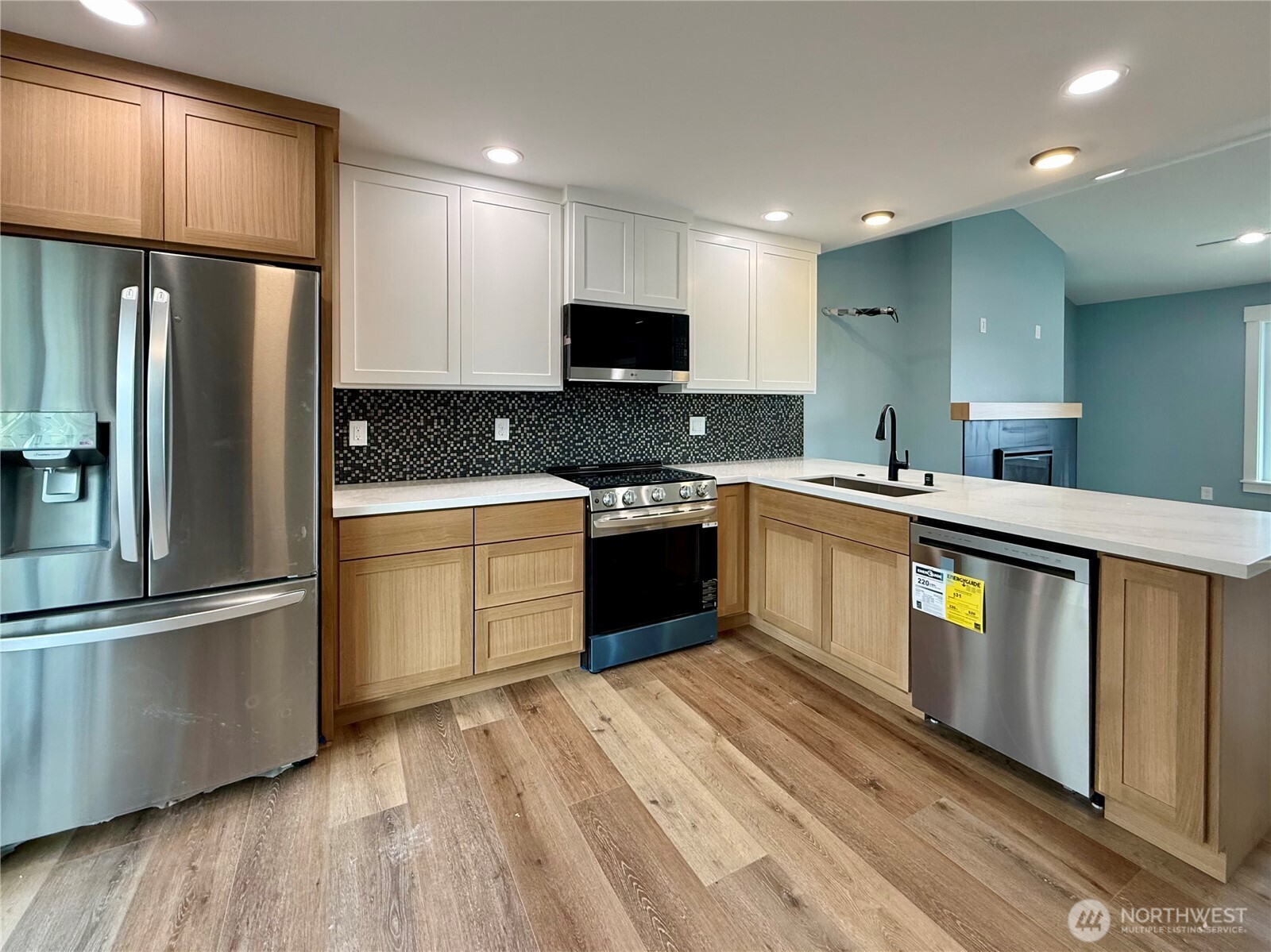 716 Reporter Court Southwest Ocean Shores, WA 98569 - Photo 14 of 36 a kitchen with stainless steel appliances granite countertop a refrigerator a sink dishwasher a stove and a refrigerator