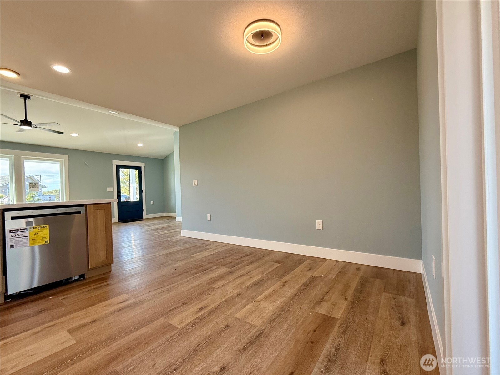 716 Reporter Court Southwest Ocean Shores, WA 98569 - Photo 15 of 36 an empty room with wooden floor and windows