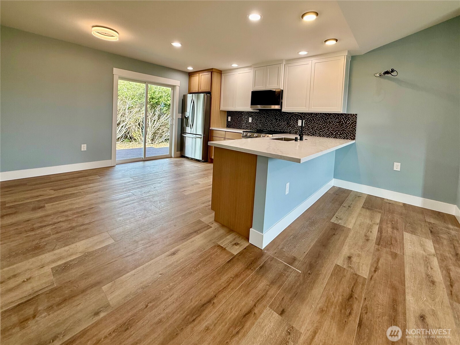 716 Reporter Court Southwest Ocean Shores, WA 98569 - Photo 18 of 36 a kitchen with stainless steel appliances granite countertop a stove a sink and a microwave