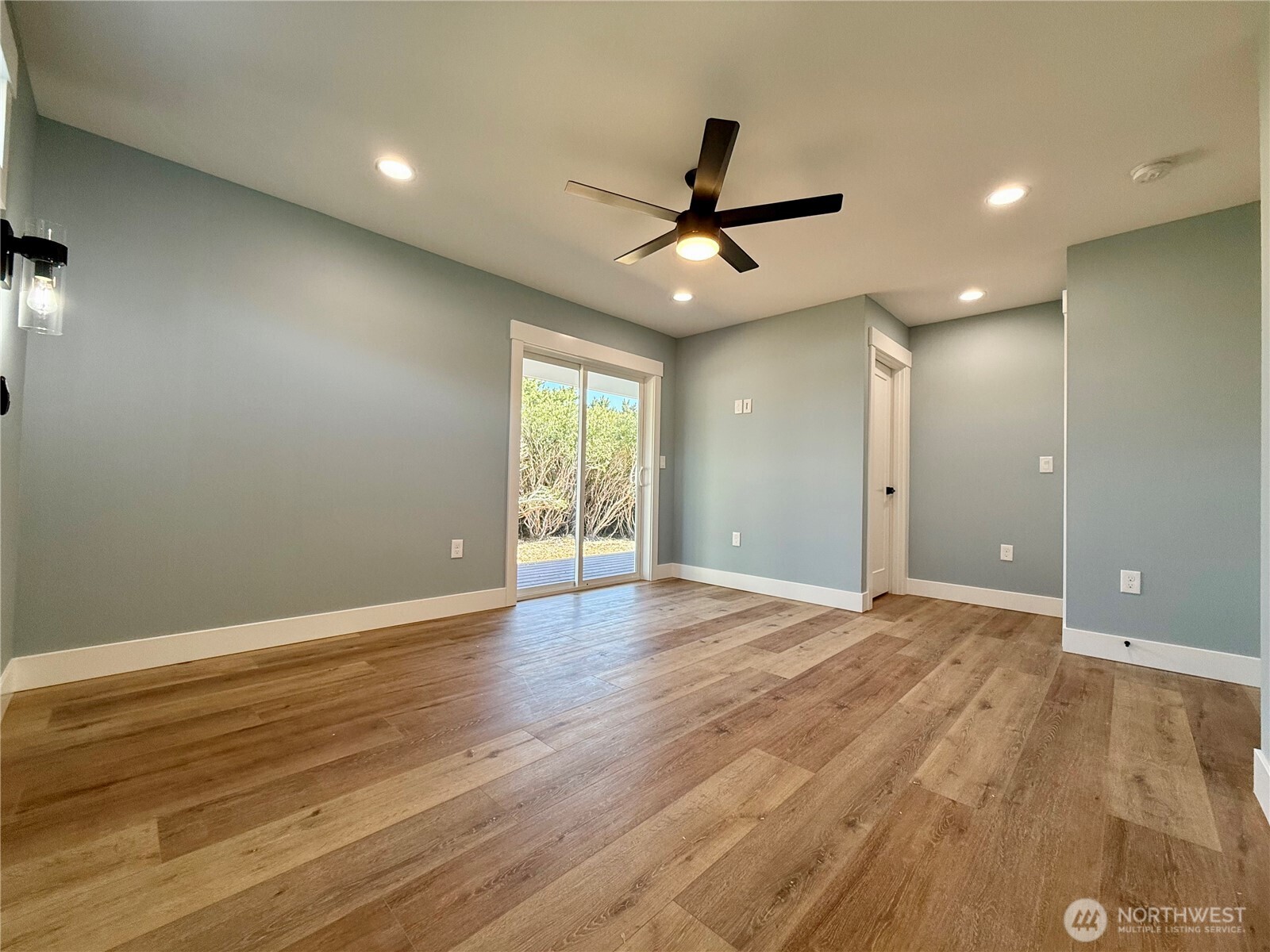 716 Reporter Court Southwest Ocean Shores, WA 98569 - Photo 22 of 36 an empty room with wooden floor and windows