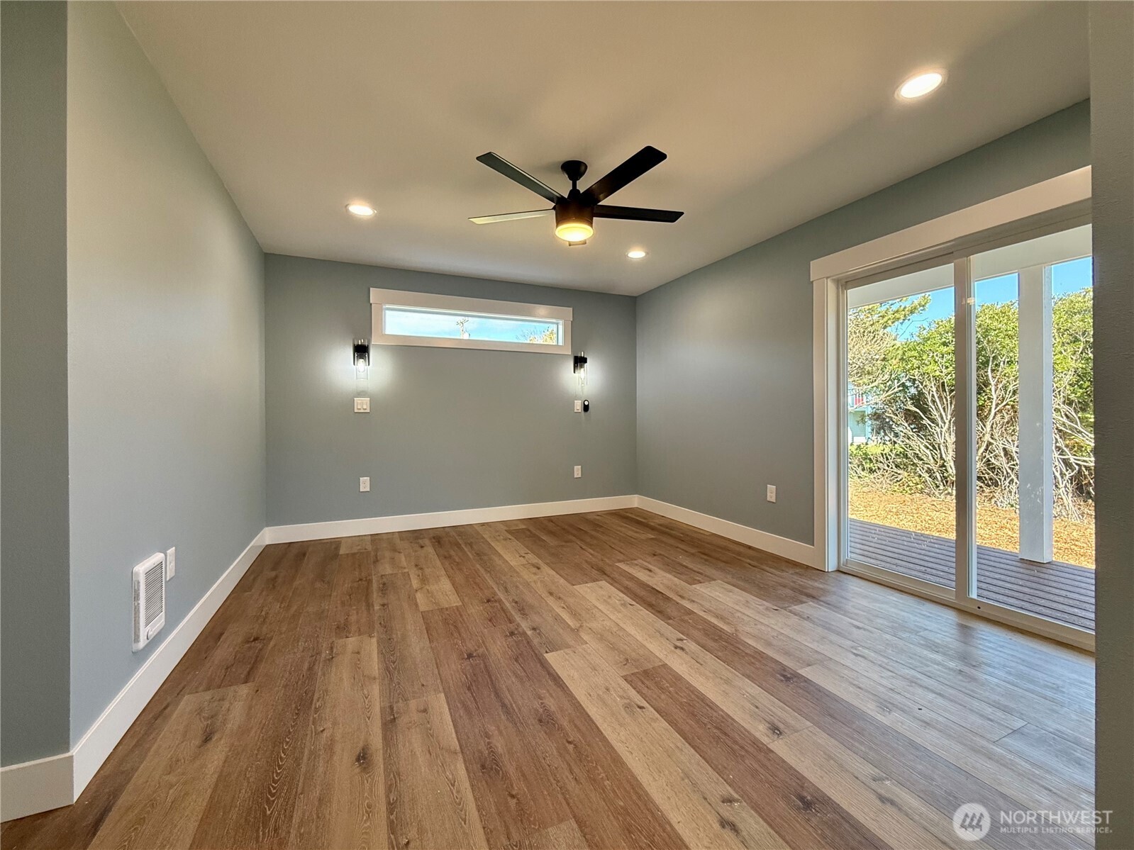 716 Reporter Court Southwest Ocean Shores, WA 98569 - Photo 24 of 36 an empty room with wooden floor and windows