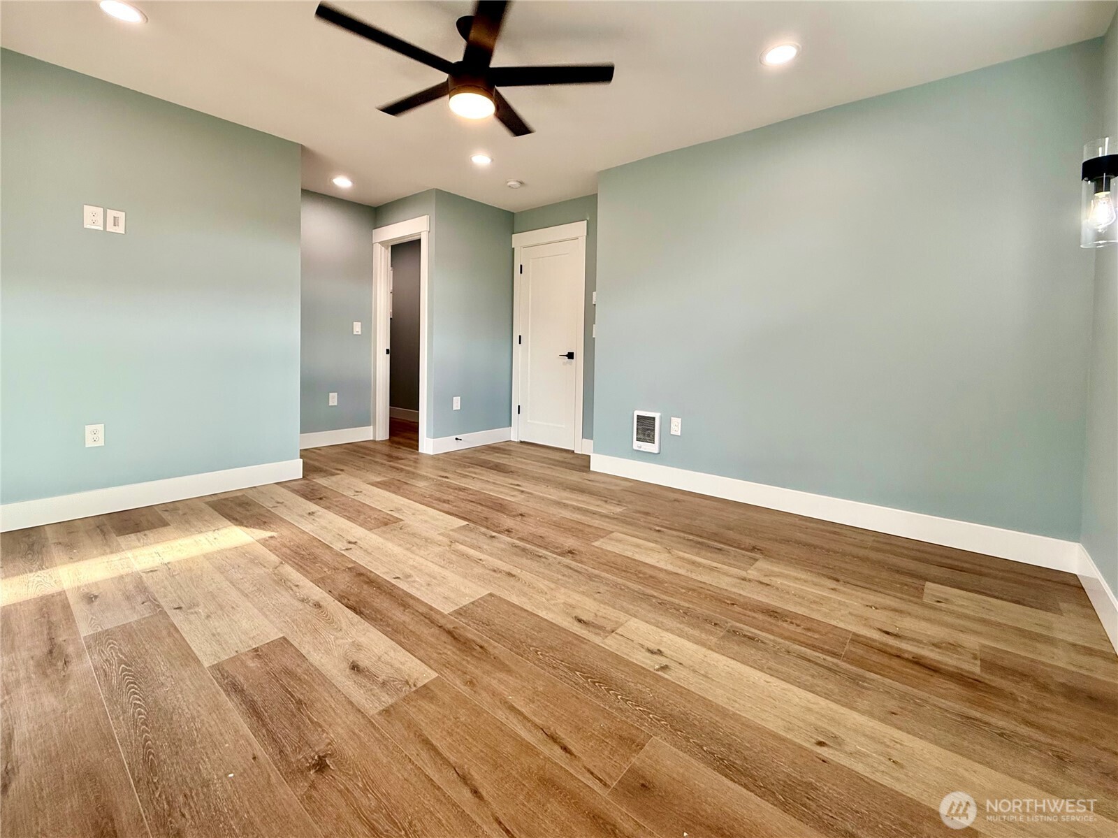 716 Reporter Court Southwest Ocean Shores, WA 98569 - Photo 26 of 36 an empty room with wooden floor and windows