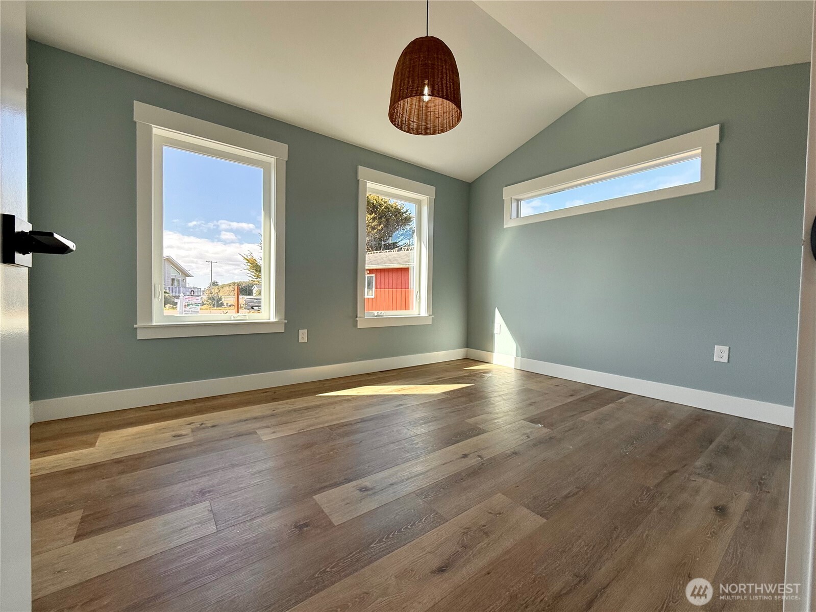 716 Reporter Court Southwest Ocean Shores, WA 98569 - Photo 32 of 36 a view of an empty room with window and wooden floor
