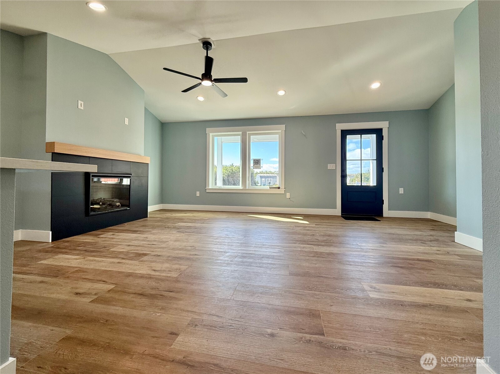 716 Reporter Court Southwest Ocean Shores, WA 98569 - Photo 8 of 36 a view of empty room with wooden floor and fan