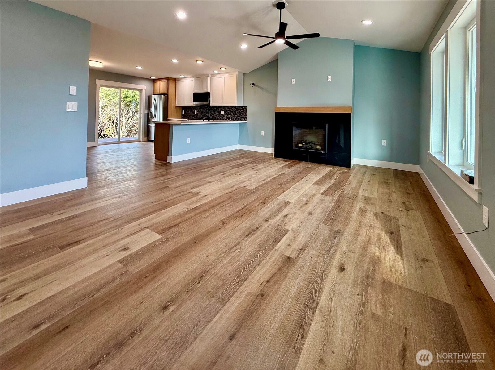 716 Reporter Court Southwest Ocean Shores, WA 98569 - Photo 10 of 36 an open kitchen view with fireplace and a window