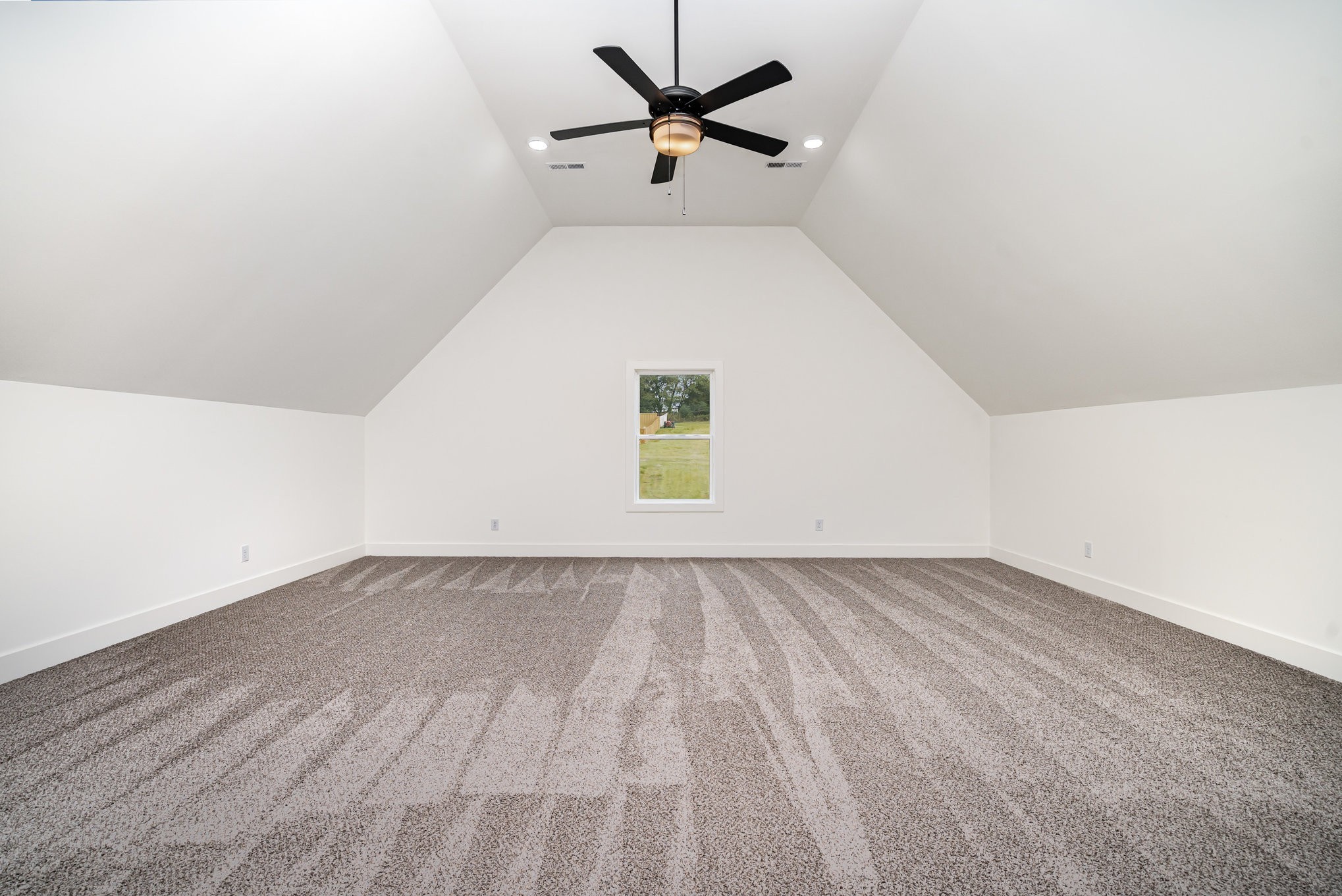 115 Crenshaw Road Hartsville, TN 37074 - Photo 28 of 40 an empty room with a chandelier fan and windows