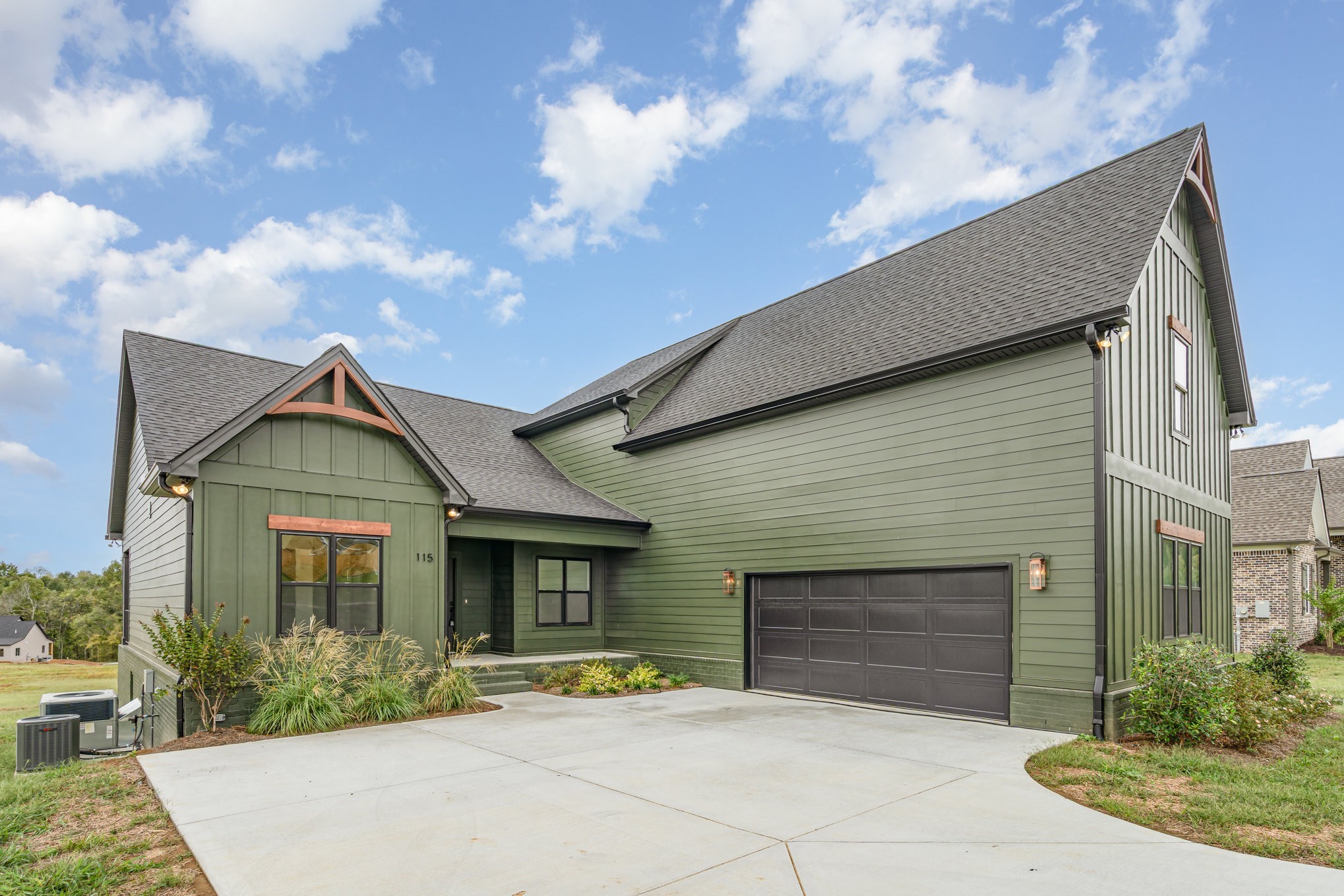 115 Crenshaw Road Hartsville, TN 37074 - Photo 3 of 40 a front view of a house with a yard and garage