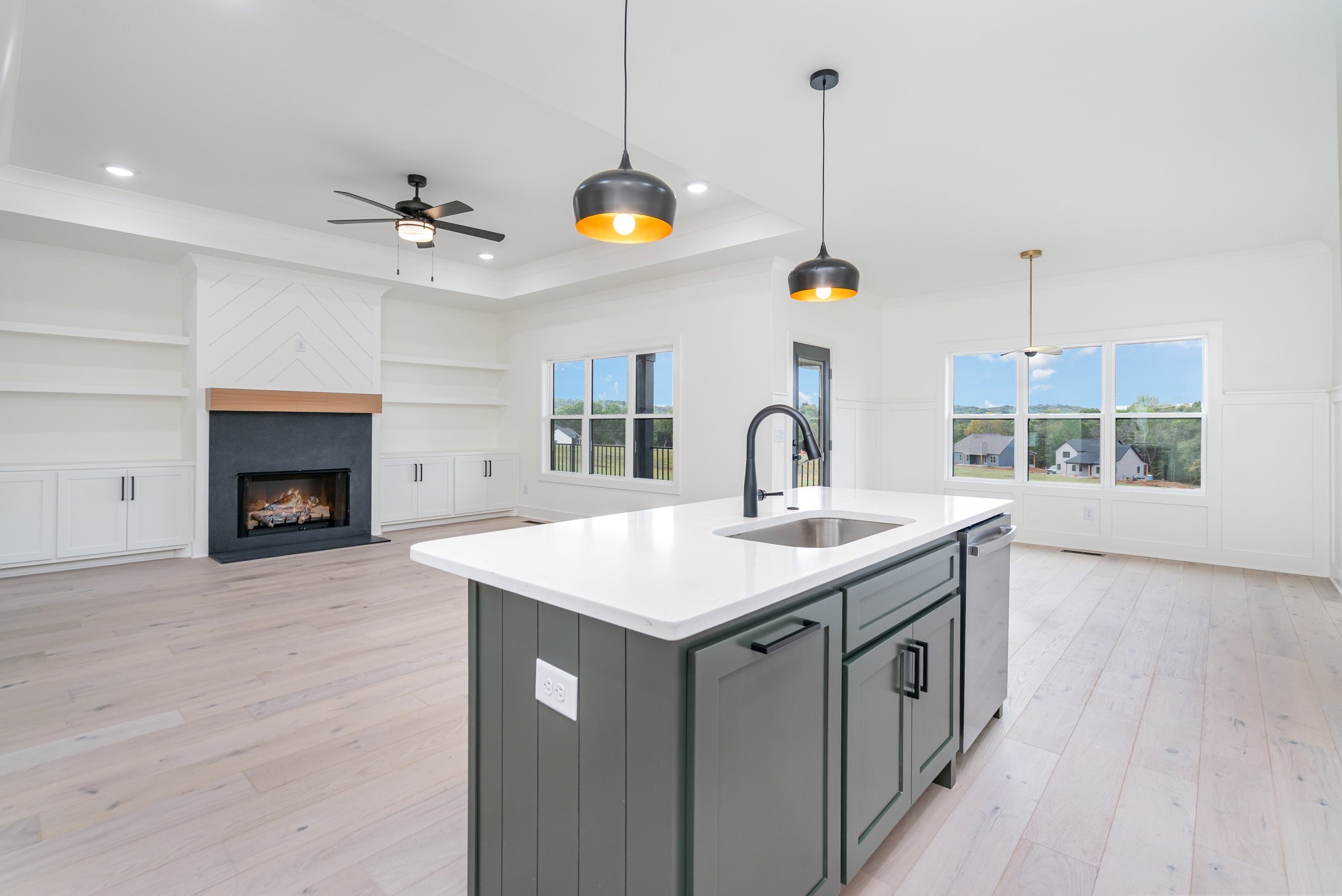 115 Crenshaw Road Hartsville, TN 37074 - Photo 10 of 40 a kitchen with a sink a chandelier stainless steel appliances and a fireplace