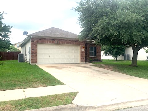 Ranch-style house featuring driveway, an attached garage, and brick siding