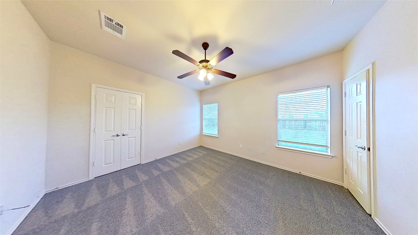 308 Rinehardt Street Hutto, TX 78634 - Photo 20 of 30 Unfurnished bedroom with dark colored carpet, ceiling fan, and a closet
