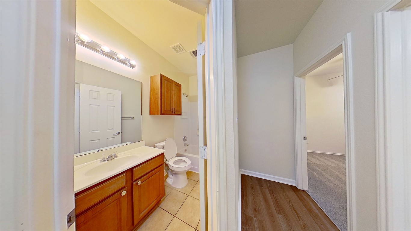 308 Rinehardt Street Hutto, TX 78634 - Photo 23 of 30 Full bath with vanity, light wood-style flooring, and tub / shower combination