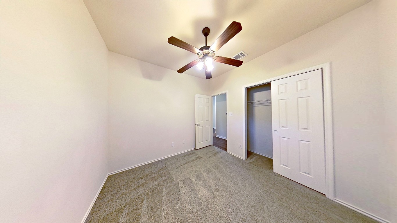 308 Rinehardt Street Hutto, TX 78634 - Photo 24 of 30 Unfurnished bedroom featuring carpet, ceiling fan, and a closet