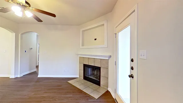 a view of a livingroom with a fireplace and window