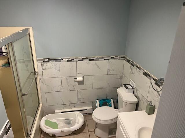 1127 Steele Circle Bushkill, PA 18324 - Photo 14 of 17 a white toilet sitting next to a bathroom sink and a mirror