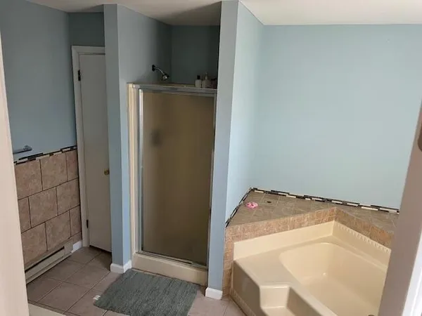 a bathroom with a tub and utility