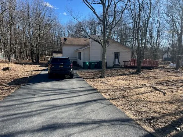 a view of a house with a yard covered in snow