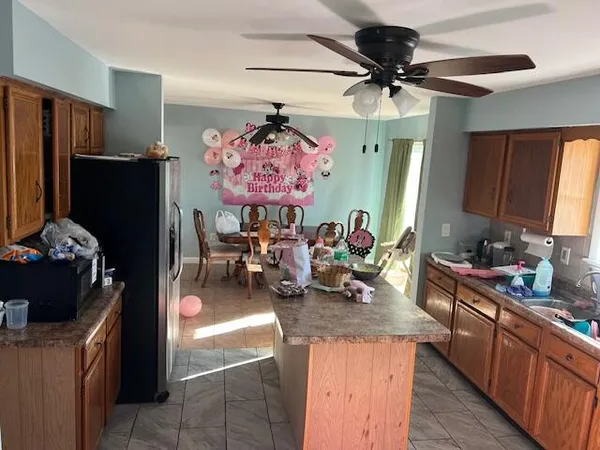 a kitchen with refrigerator and cabinets