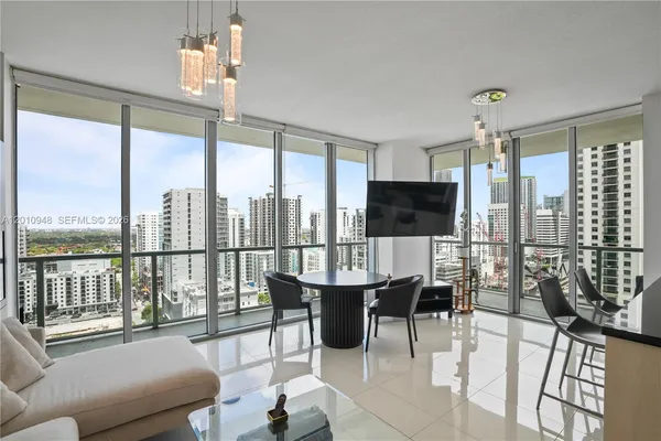 a living room with furniture tv and a large window
