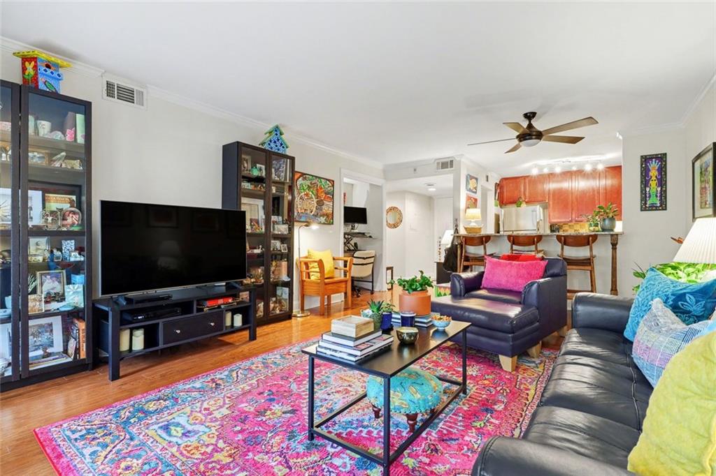 3650 Ashford Dunwoody Road Northeast, Unit 904 Atlanta, GA 30319 - Photo 11 of 33 a living room with furniture and a flat screen tv